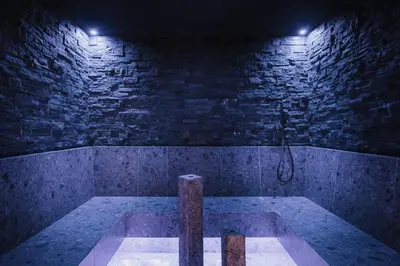 a room with a bath tub in a brick wall at Pensione Camoscio in La Villa