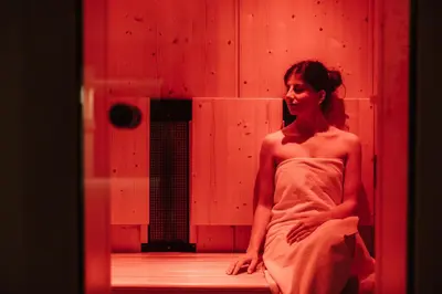 a woman in a dress sitting in a room at Pensione Camoscio in La Villa