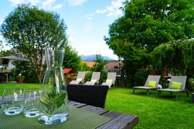 a table with glasses and a vase on top of it at Residence Walder in Falzes