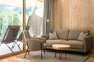 a living room with a couch and a table at Naturhotel Rainer in Racines