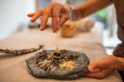 a person is sprinkling food on top of a table at Naturhotel Rainer in Racines