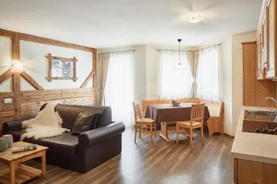 a living room with a couch and a table at Residence Baron in San Vigilio Di Marebbe