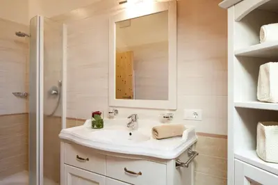 a bathroom with a sink and a shower at Residence Baron in San Vigilio Di Marebbe