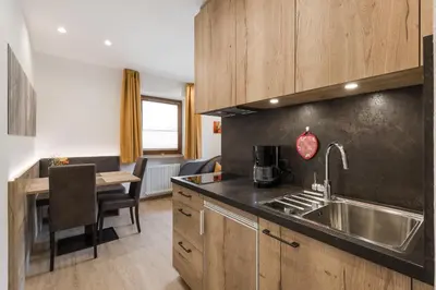a kitchen with a sink and a counter top at Residence Neuhof in Tirolo