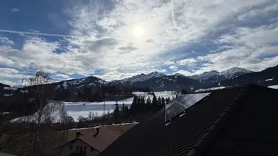a view of a snowy mountain with the sun in the sky at NoveCase Smart Holidays - Gasthof Neunhaeusern in Rasùn di Sotto