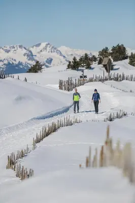 two people are skiing down a snow covered slope at NoveCase Smart Holidays - Gasthof Neunhaeusern in Rasùn di Sotto