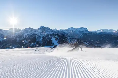 two people are skiing down a snow covered mountain at NoveCase Smart Holidays - Gasthof Neunhaeusern in Rasùn di Sotto