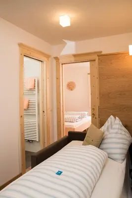 a room with a bed with a window and a bedroom at Pension Talblick in Laion