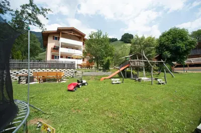 a park with a playground with a slide and a swing at Pension Talblick in Laion