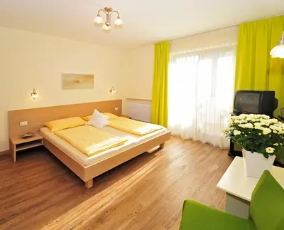 a bedroom with a bed and a tv in it at Residence Mignon in Rifiano
