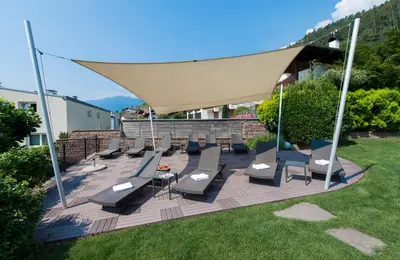 a group of chairs on a patio with a canopy at Residence Mignon in Rifiano