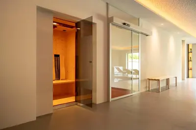 a room with a glass door and a table at Residence Mignon in Rifiano