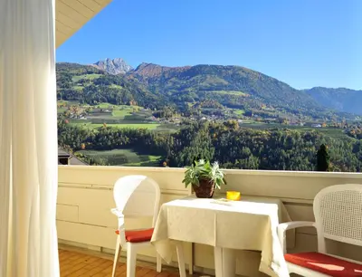 a table and chairs with a view of a mountain at Residence Mignon in Rifiano