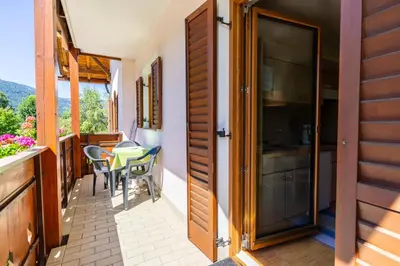 a room with a balcony with a table and chairs at Residence Sporting in Brunico