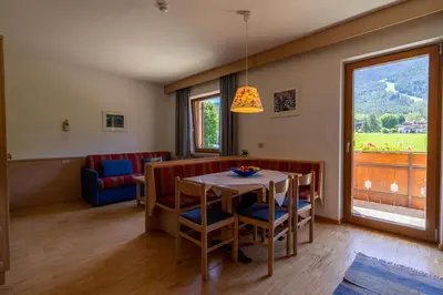 a dining room with a table and chairs and a window at Residence Sporting in Brunico
