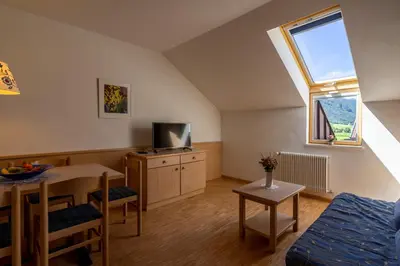 a small living room with a table and a tv at Residence Sporting in Brunico