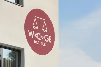 a sign for a bar pub on the side of a building at Appartments Waage in Bressanone