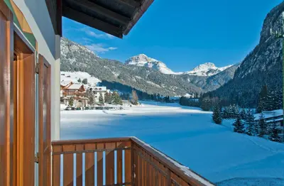 a balcony with a view of a snow covered mountain at Cesa Edelweiss Living & Spa in Campitello di Fassa