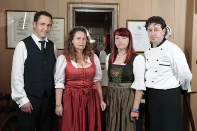 a group of people posing for a picture at Hotel Alpino Plan in Selva di Val Gardena