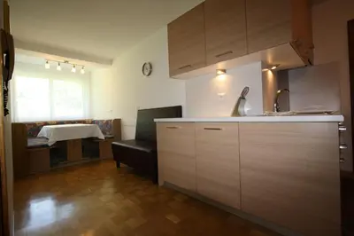 a kitchen with a sink and a table in a room at Pera Ciaslat in Colfosco