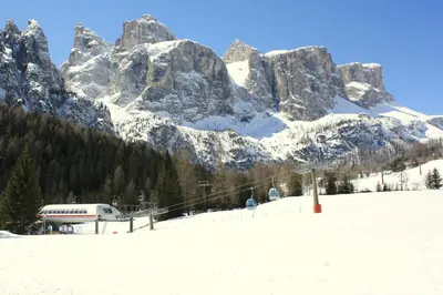 a ski lift in front of a snow covered mountain at Pera Ciaslat in Colfosco