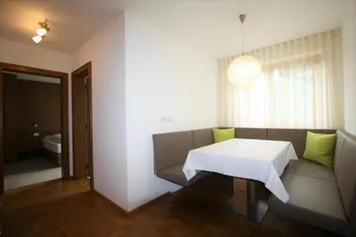 a living room with a table and a couch at Pera Ciaslat in Colfosco