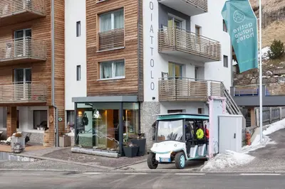 a small vehicle parked in front of a building at Hotel Scoiattolo in Tesero