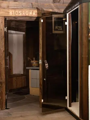 an open door in a room with a kitchen at Hotel Scoiattolo in Tesero