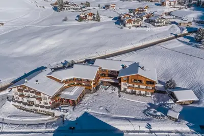 an aerial view of a resort in the snow at Hotel Welponer in Selva di Val Gardena