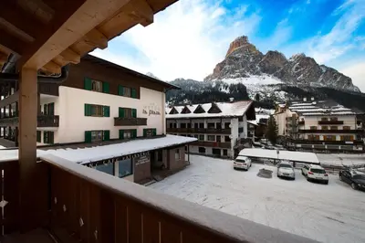 a view from a balcony of a town with a mountain at Appartamenti Villa Olympia in Corvara in Badia