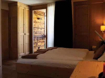 a bedroom with a bed and an open window at Garni Le Maddalene in Coredo