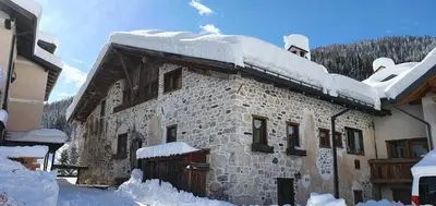 two views of a floor plan of aominium at Rustico nelle Dolomiti in Val di Zoldo