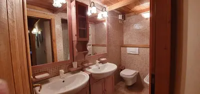 a kitchen with a stove and a microwave at Rustico nelle Dolomiti in Val di Zoldo