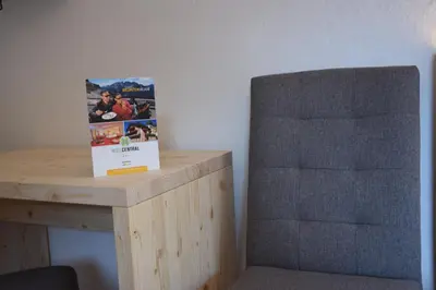 a hotel room with a bed and a tv at Hotel Central in Nova Levante