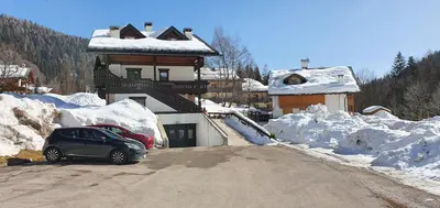 a car parked on the side of a snow covered road at Casa Piva Dolomiti in Val di Zoldo