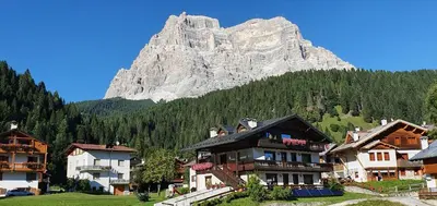 a group of houses in front of a mountain at Casa Piva Dolomiti in Val di Zoldo