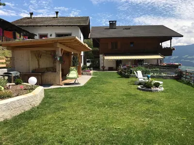 a backyard of a house with a grass yard at Zehrehof in Bressanone