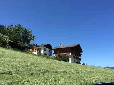 a house on the side of a grassy hill at Zehrehof in Bressanone