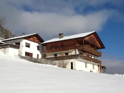 a building on top of a snow covered slope at Zehrehof in Bressanone