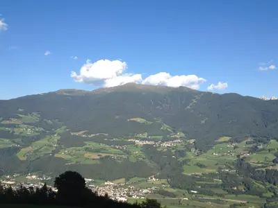 a view of a mountain with a town in the valley at Zehrehof in Bressanone