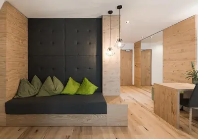 a bedroom with a bed with green pillows at Park Hotel Villa Etschland in Plaus