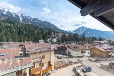 a view of a town with mountains in the background at Chalet Catinaccio in Soraga