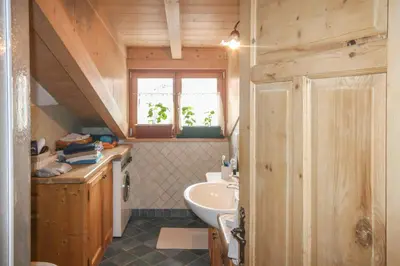 a small bathroom with a sink and a sink at Tabià Elisa in Campitello di Fassa
