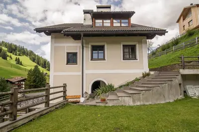 a small house on top of a hill at Casa Matie in Selva di Val Gardena