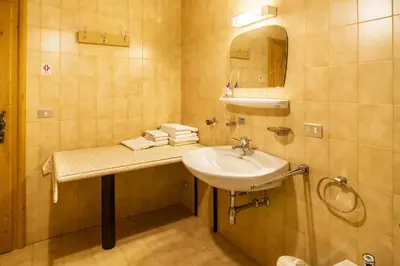 a bathroom with a sink and a mirror at Casa Matie in Selva di Val Gardena
