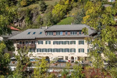 a large building in the snow with a fountain at Hotel Kabis in Funes