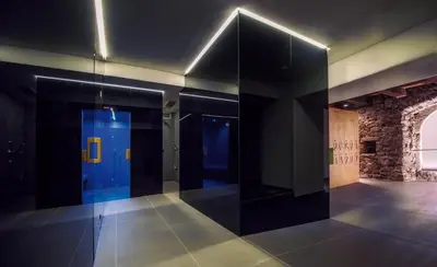 a hallway with a blue door in a building at Hotel Kabis in Funes