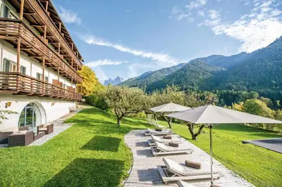 a large white building in the middle of a mountain at Hotel Kabis in Funes