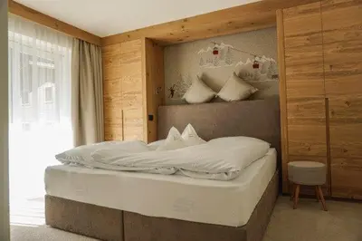 a bedroom with a large bed in a room at Garni B&B Schenk in Selva di Val Gardena