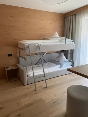 a room with two bunk beds in a room at Garni B&B Schenk in Selva di Val Gardena